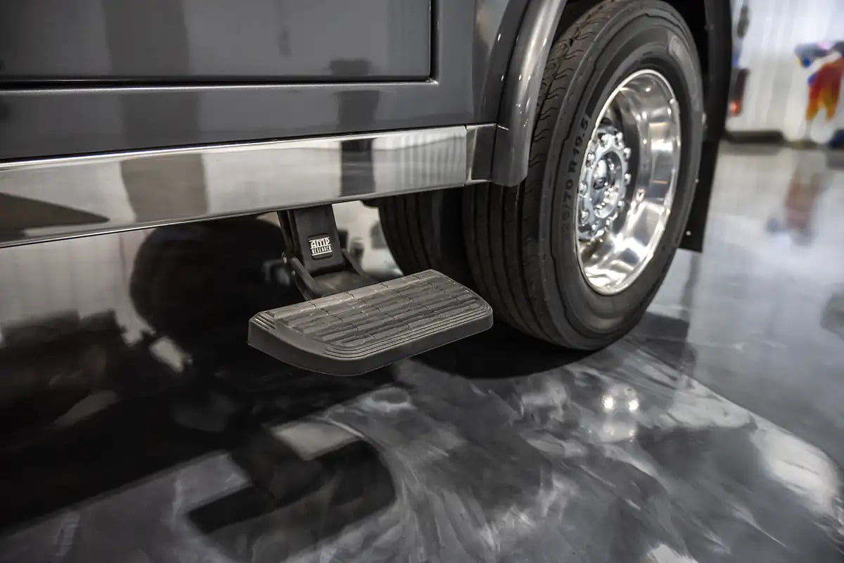 Close-up of a drop-down step at the Luxe Truck's bed base, designed to improve access for fifth wheel RV hauler trucks.
