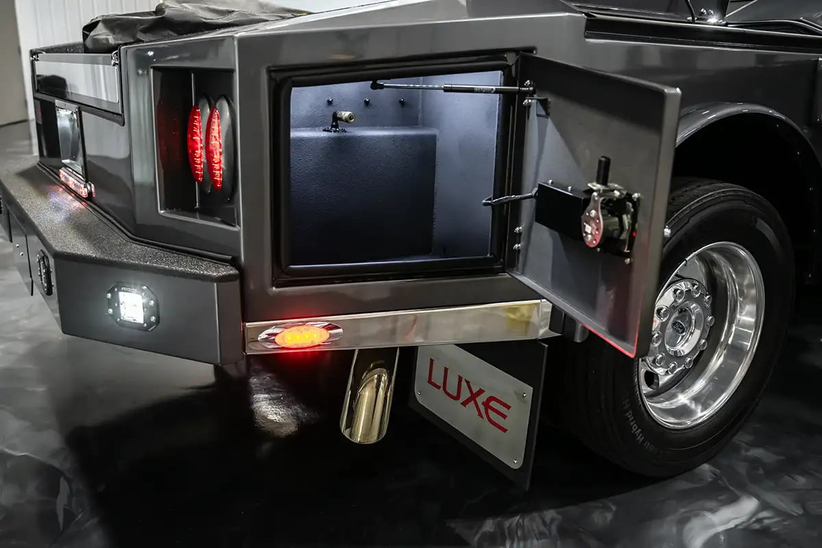 Detail of a side compartment on a Luxe Truck, featuring the compressed air access chuck, tailored for the specialized utilities of a fifth wheel RV hauler truck.